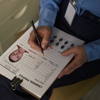 Middle Aged Caucasian Woman Filling Criminal Profile Form for Prisoned Middle Aged Caucasian Woman Filling Criminal Profile Form for Prisoned